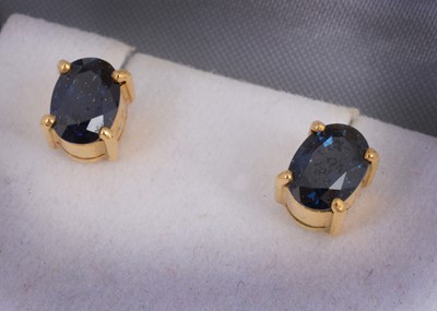 Lot 100 - A pair of sapphire yellow metal stud earrings