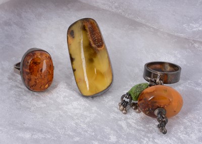 Lot 135 - Three continental silver and amber dress rings