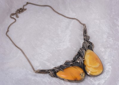 Lot 140 - A large double amber pebble white metal set necklace