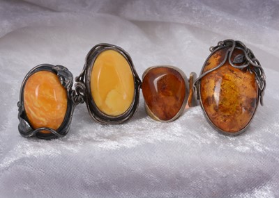 Lot 141 - Three silver and amber dress rings