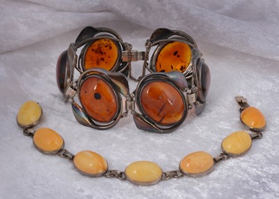 Lot 143 - Two amber and white metal bracelets