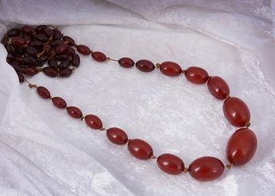 Lot 144 - An antique string of cherry amber knotted strung beads