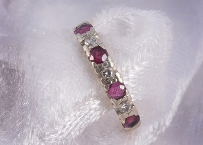 Lot 156 - A 9ct gold ruby and diamond half hoop eternity ring