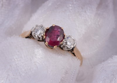 Lot 199 - A 18ct gold ruby and diamond three stone dress ring
