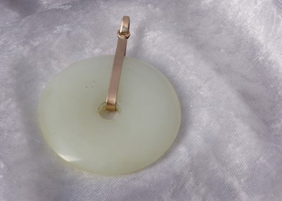 Lot 213 - A Chinese jadeite jade disc pendant