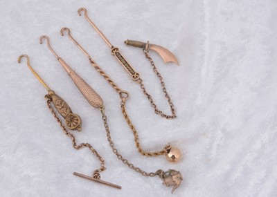 Lot 217 - Four various lapel button hooks