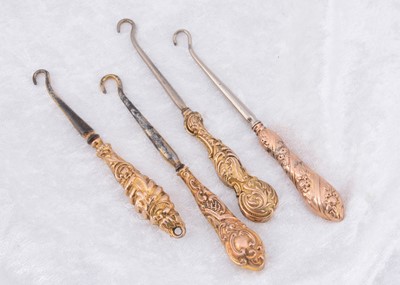 Lot 220 - Four 9ct gold handled steel button hooks