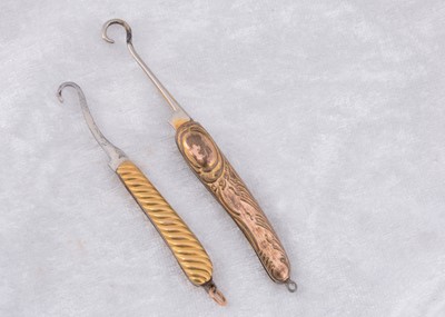 Lot 227 - Two Edwardian gold plated folding button hooks