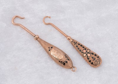 Lot 228 - Two continental yellow metal and enamel fixed button hooks