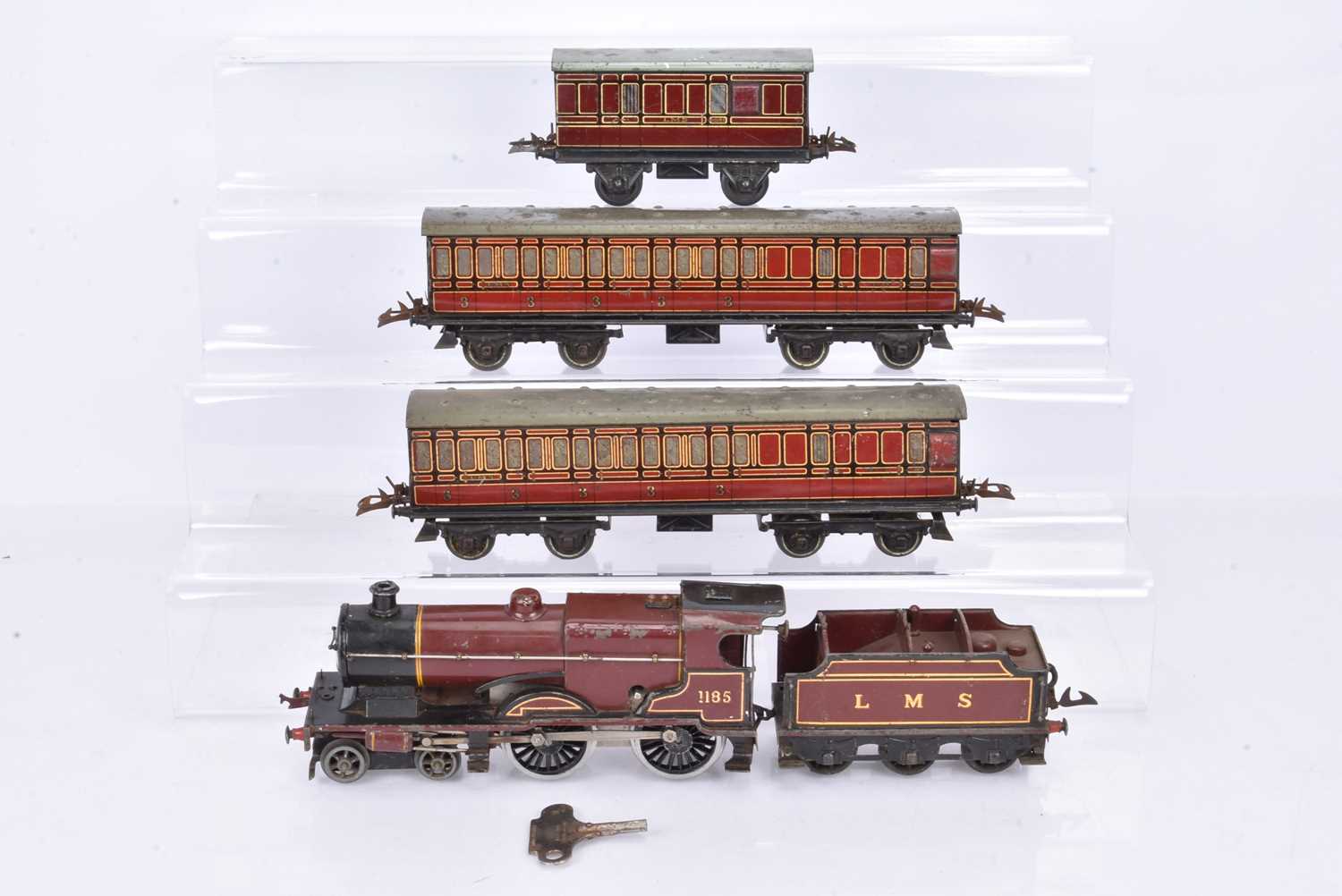 Lot 180 - Hornby 0 Gauge clockwork LMS maroon No 2 Special 4-4-0 Compound 1185 Locomotive and Tender and Suburban Coaches