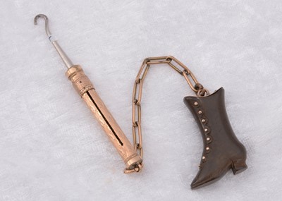 Lot 231 - A Victorian vulcanite and gold plated lapel novelty button hook