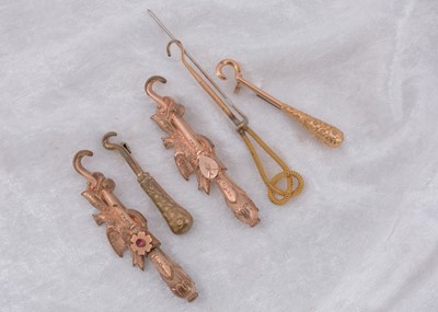 Lot 234 - Five gold plated button hook pins and brooches