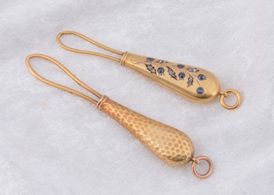 Lot 237 - Two continental yellow metal button loops