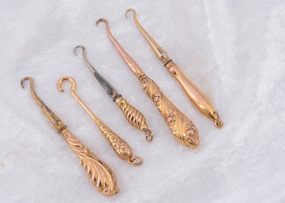 Lot 245 - Four Victorian 9ct gold button hooks