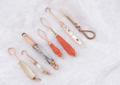 Lot 255 - Seven organic and gilt metal button loops and hooks