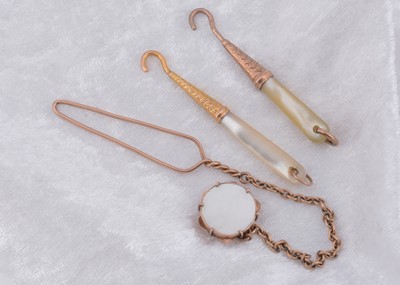 Lot 261 - Three mother of pearl button loops and hooks