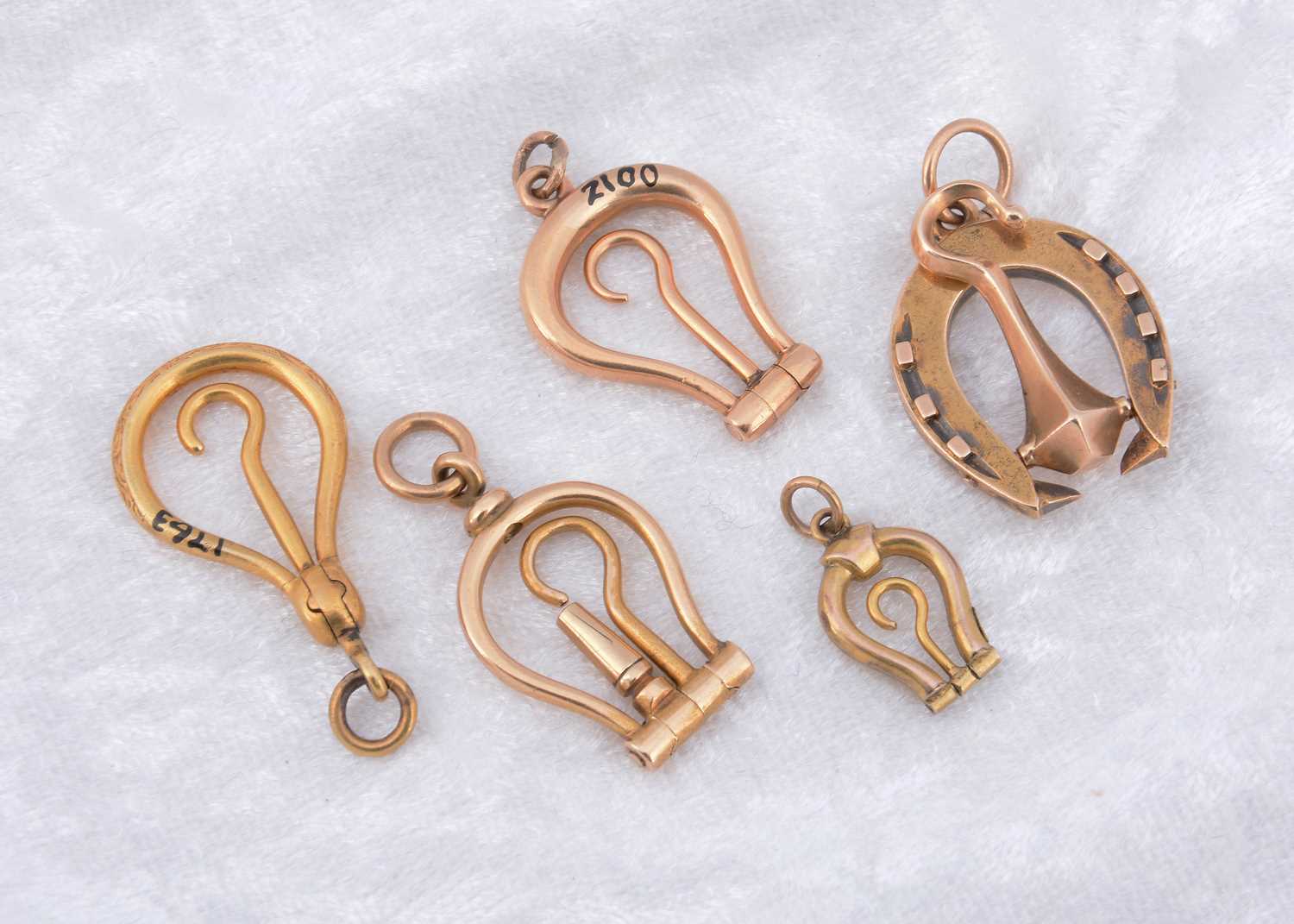 Lot 270 - A collection of miniature folding horseshoe shaped button hooks