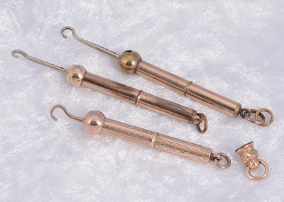 Lot 288 - Three gilt metal protracting button hooks