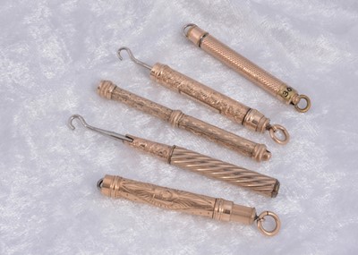 Lot 289 - Five gilt metal protracting button hooks