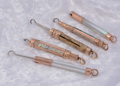 Lot 291 - Four mother of pearl protracting gilt metal Victorian button hooks