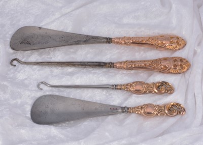 Lot 294 - Two matched pairs of hooks and shoehorns