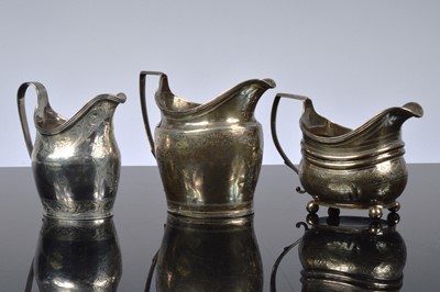 Lot 396 - Three George IIII silver milk jugs