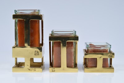 Lot 173 - A set of three David Marshall brass candlesticks