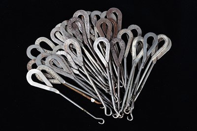 Lot 435 - A collection of steel advertising button hooks