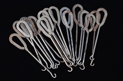 Lot 437 - A collection of steel advertising button hooks