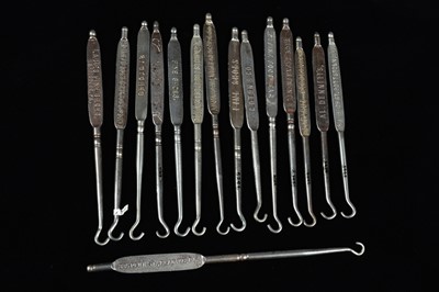 Lot 444 - A collection of steel advertising button hooks
