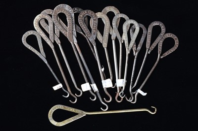 Lot 450 - A collection of steel advertising  button hooks