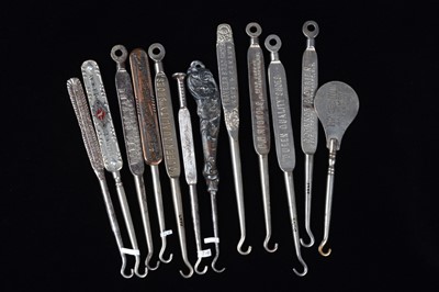 Lot 451 - A collection of steel advertising  button hooks