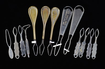 Lot 453 - A collection of steel and brass flat button loops