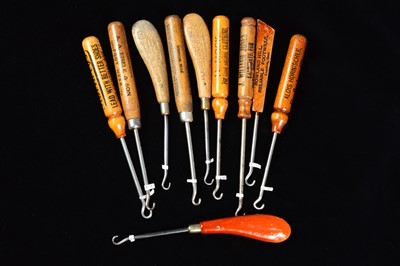 Lot 457 - A collection of turned and carved wooden handled button hooks