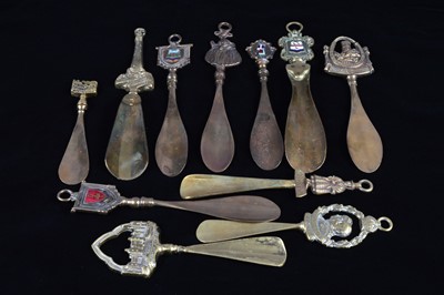 Lot 464 - A collection of eleven brass souvenir shoehorns