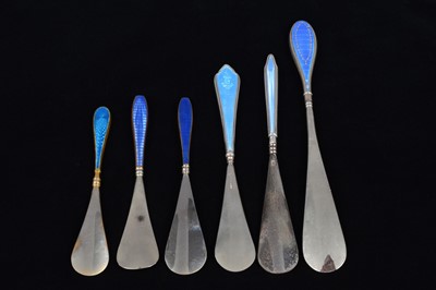 Lot 470 - Six blue guilloche enamelled handled shoehorns