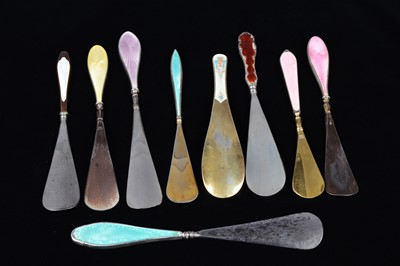 Lot 471 - Nine guilloche enamel handled shoehorns