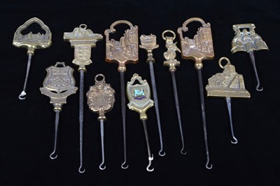 Lot 474 - A collection of steel brass handle mounted souvenir and commemorative button hooks