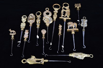 Lot 475 - A collection of steel brass handle mounted souvenir and commemorative button hooks