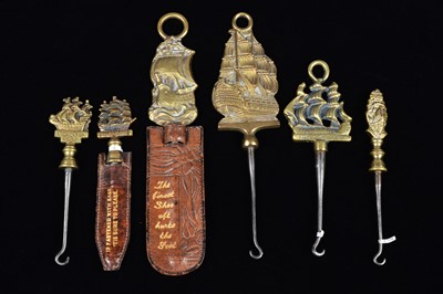 Lot 476 - A collection of steel brass handle mounted souvenir and commemorative button hooks