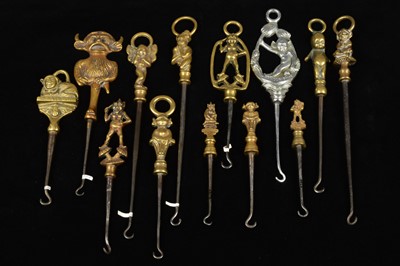 Lot 479 - A collection of steel brass handle mounted souvenir and commemorative button hooks