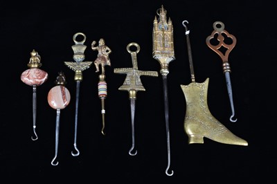 Lot 480 - A collection of steel brass handle mounted souvenir and commemorative button hooks