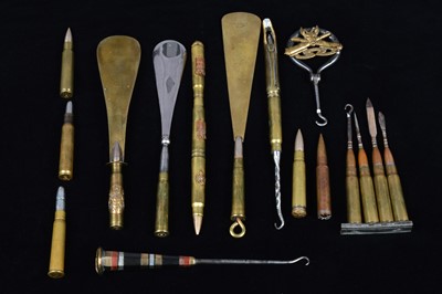 Lot 486 - A collection of trench art converted shell button hooks and accessories