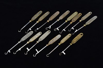 Lot 487 - A collection of 19th Century steel and brass flattened souvenir button hooks