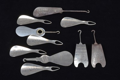 Lot 496 - A collection of advertising steel combination button hook or loop and shoehorns