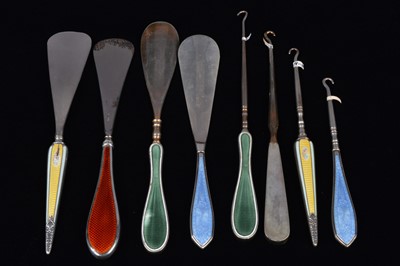 Lot 498 - Four sets of matching guilloche enamel silver handled button hooks and shoehorns