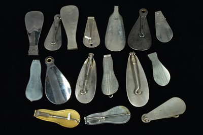 Lot 509 - A collection of chromed and steel combination button hooks and loops and shoehorns
