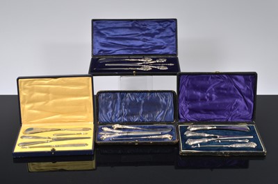 Lot 516 - Three cased silver handled four piece dressing table sets