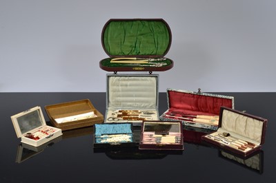 Lot 519 - Eight cased Victorian and later bone and resin dressing table sets