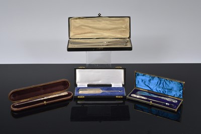 Lot 520 - Three cased silver handled button hooks and shoehorns